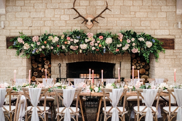 The Barn at Berkeley set up for a wedding, banquet table and mantlepiece florals