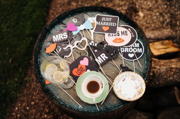 photo booth props laid out on the top of a barrel