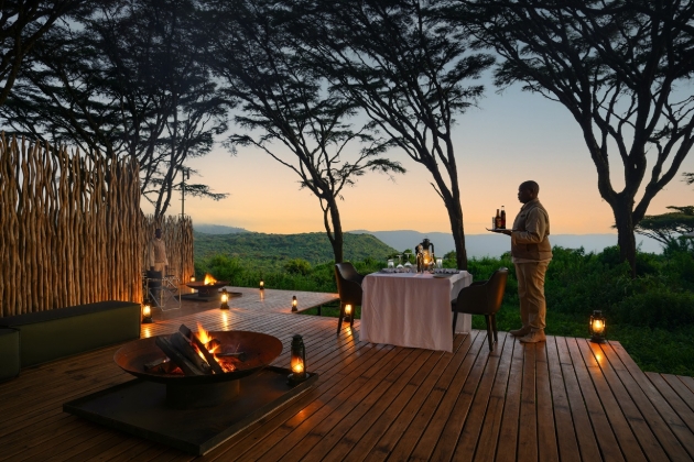 dinner for two at night with waiter ready to serve drinks outdoors 